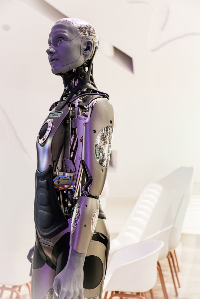 Services Sleek humanoid robot displayed in a contemporary conference setting, showcasing advanced technology.