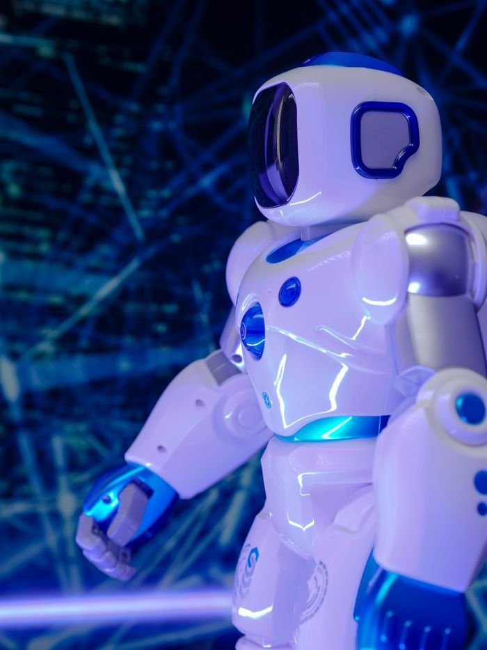 About Close-up of a modern humanoid robot with glowing blue lights and futuristic design.